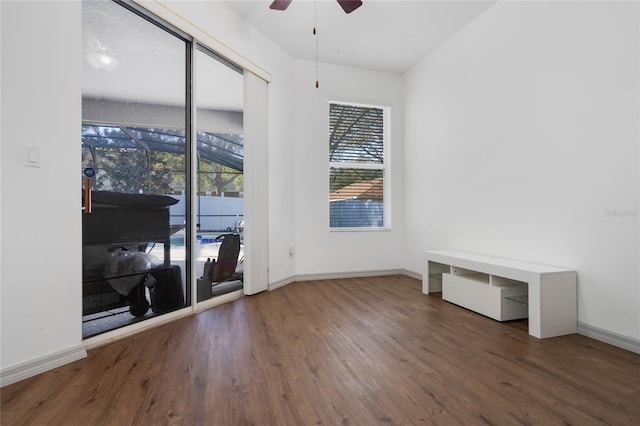 unfurnished room with a healthy amount of sunlight, baseboards, and wood finished floors