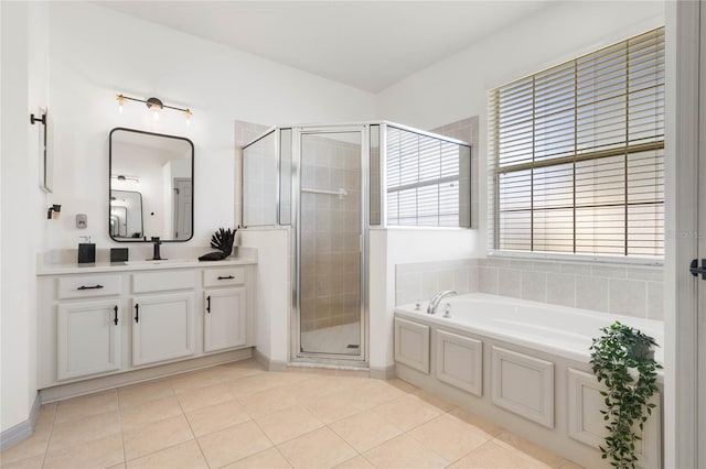 bathroom with a bath, tile patterned flooring, a shower stall, and vanity