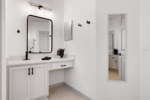 bathroom with tile patterned flooring, baseboards, and vanity