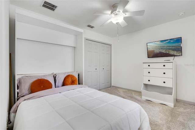 bedroom featuring a closet, carpet flooring, visible vents, and a ceiling fan