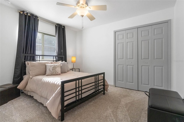 carpeted bedroom featuring a ceiling fan and a closet