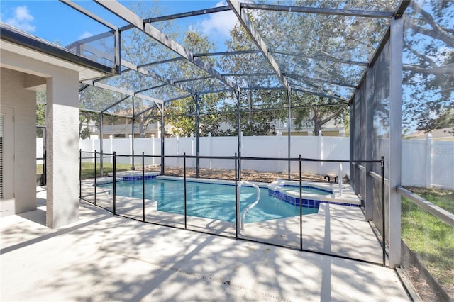 view of swimming pool with a patio, a fenced backyard, a pool with connected hot tub, and a lanai