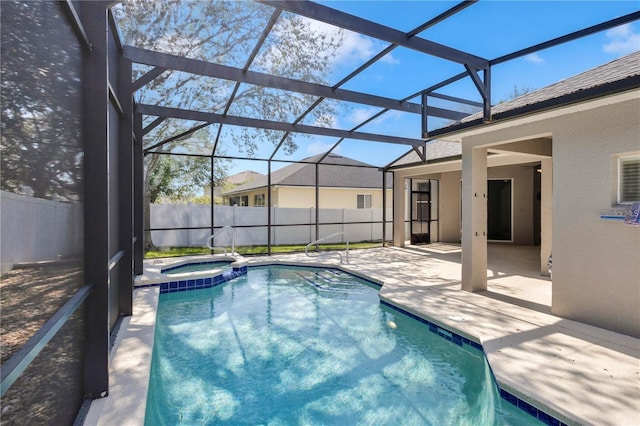 view of pool featuring a patio area, fence, a pool with connected hot tub, and a lanai