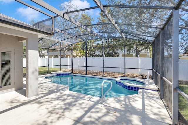 view of swimming pool featuring a lanai, a patio area, a fenced backyard, and a pool with connected hot tub