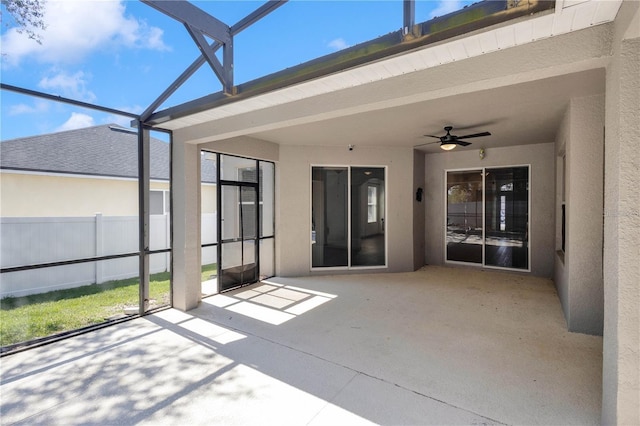 unfurnished sunroom with ceiling fan