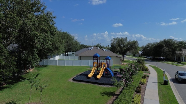 community playground with fence and a lawn