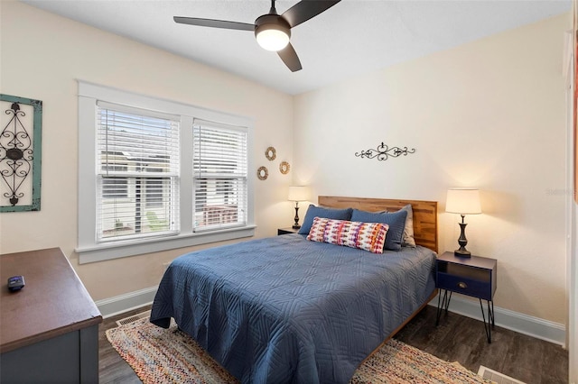 bedroom featuring baseboards, visible vents, ceiling fan, and wood finished floors