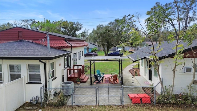 view of home's exterior featuring stucco siding, fence, a gate, and central air condition unit