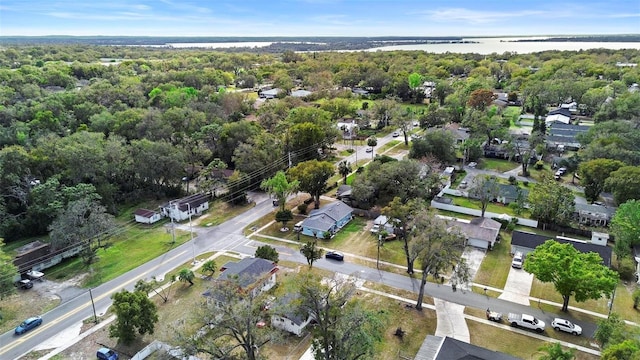 aerial view with a water view and a wooded view