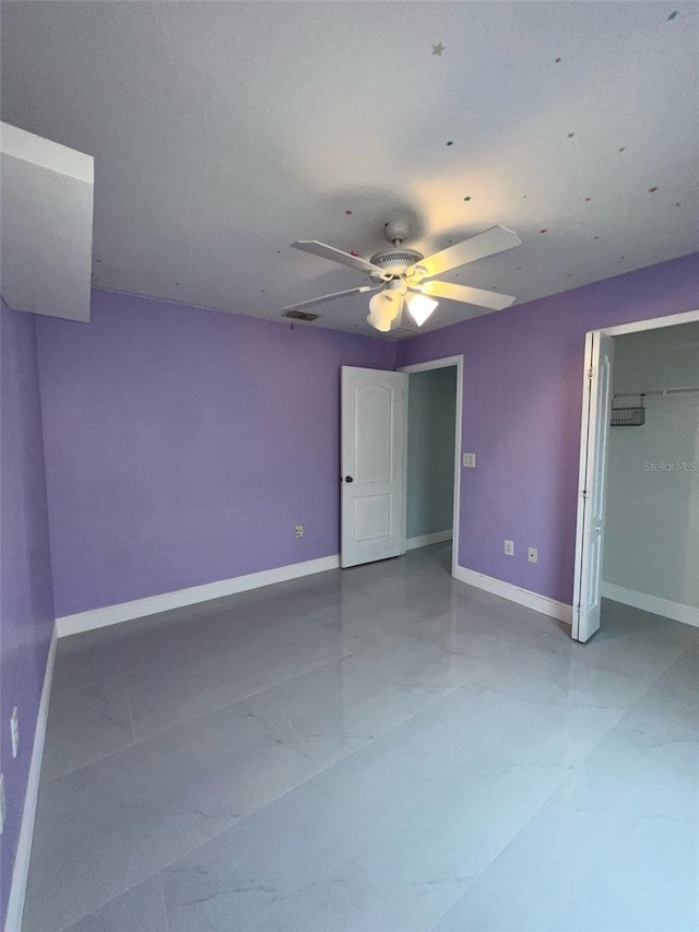 unfurnished bedroom featuring ceiling fan, a closet, visible vents, and baseboards