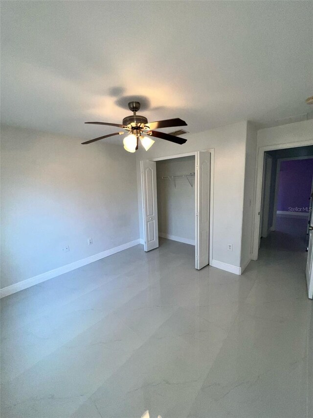 unfurnished bedroom with a closet, a ceiling fan, and baseboards