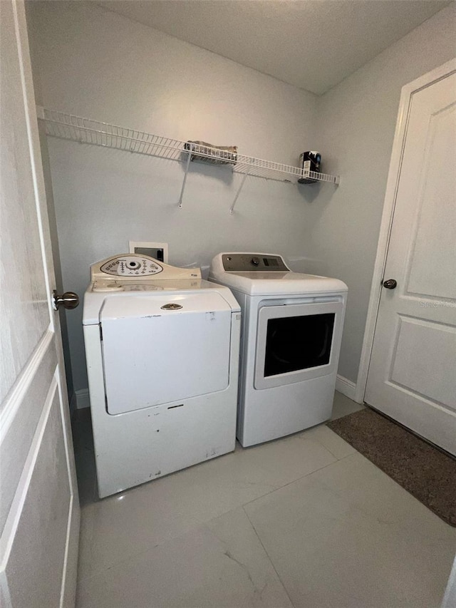 clothes washing area featuring washer and dryer and laundry area