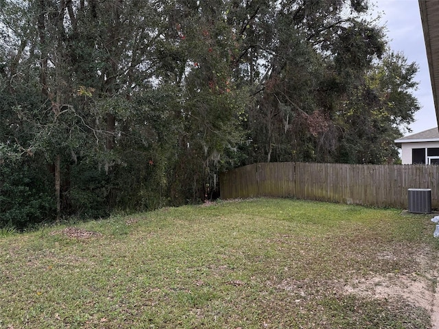 view of yard with fence and cooling unit