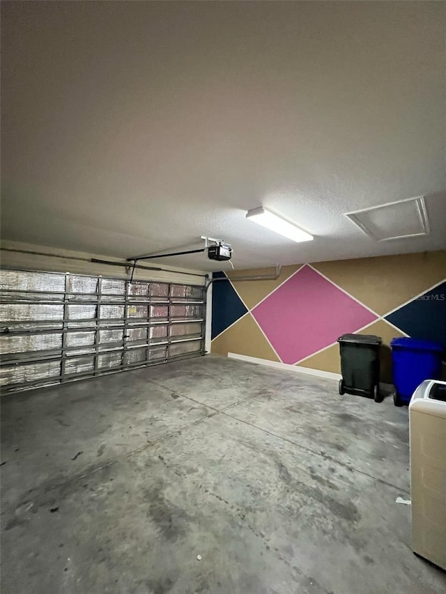 garage featuring a garage door opener and washer / dryer