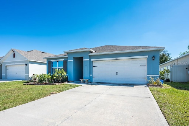 view of front of property with a garage, concrete driveway, a front lawn, and stucco siding