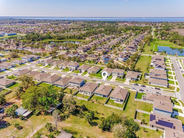 drone / aerial view with a residential view and a water view