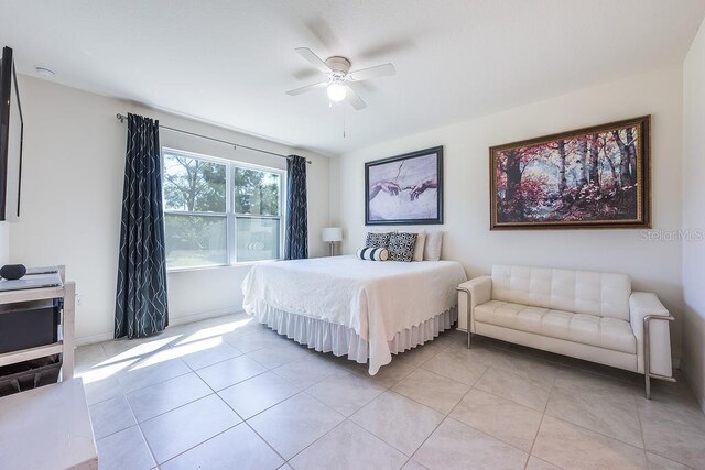 bedroom with baseboards, a ceiling fan, and light tile patterned flooring