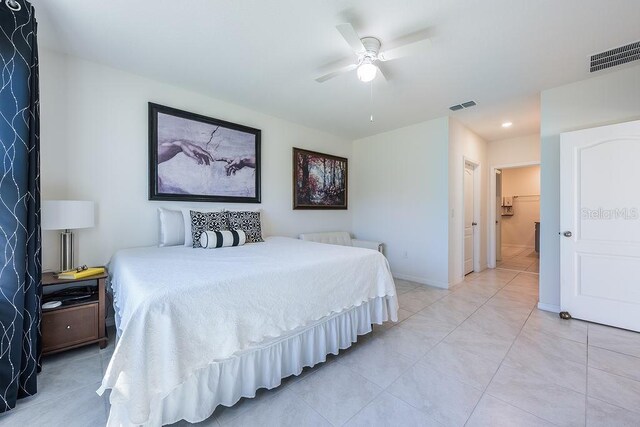 bedroom with visible vents, ceiling fan, baseboards, and light tile patterned floors