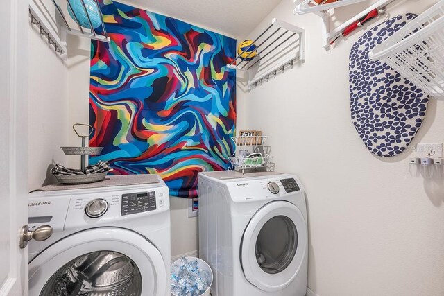 clothes washing area with laundry area and washing machine and dryer