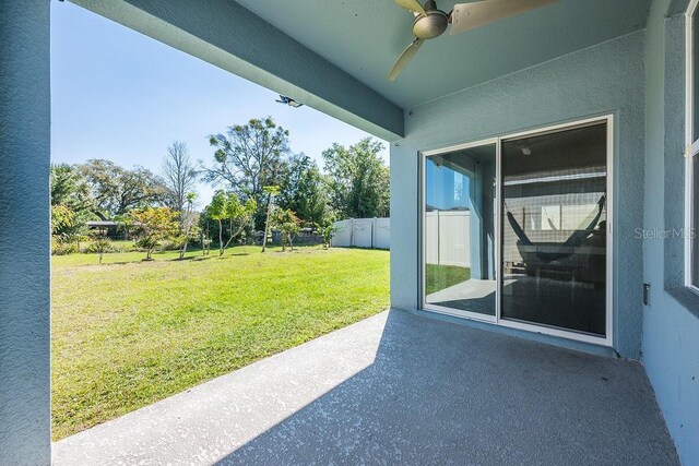 view of patio / terrace featuring fence and a ceiling fan