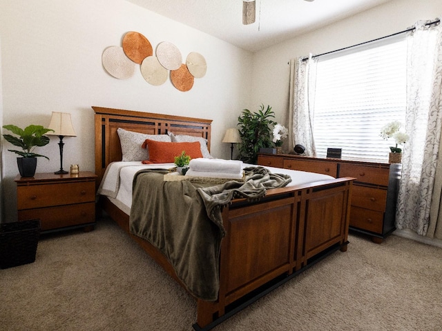 bedroom featuring a ceiling fan and light carpet