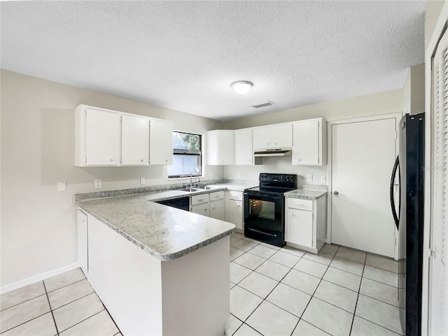 kitchen featuring visible vents, a peninsula, under cabinet range hood, black appliances, and a sink