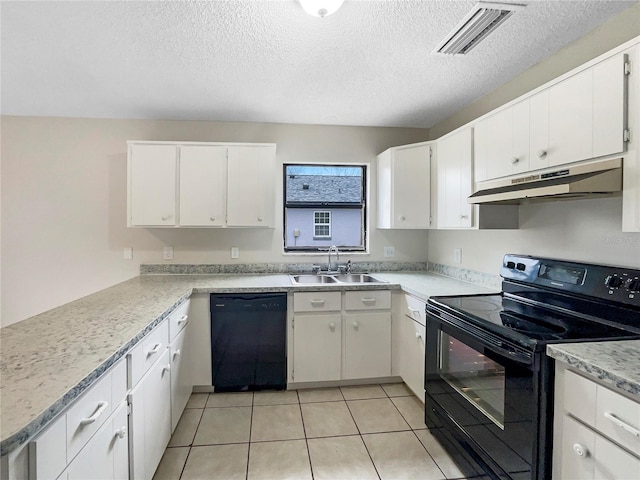 kitchen featuring light countertops, visible vents, a sink, under cabinet range hood, and black appliances