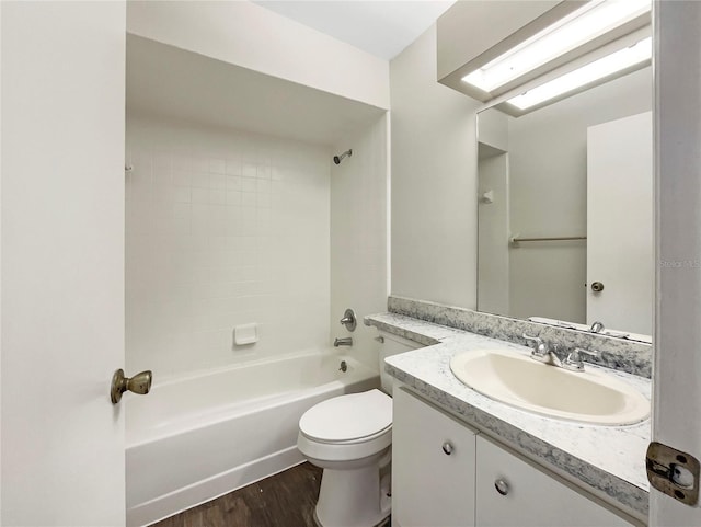 full bath with toilet, shower / bath combination, a skylight, wood finished floors, and vanity