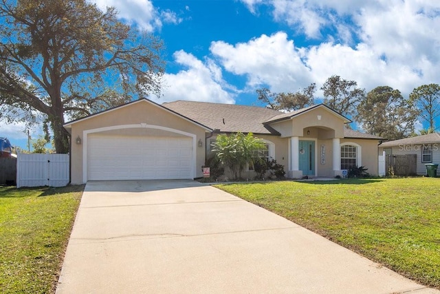 view of front of house featuring a garage, a front yard, concrete driveway, and stucco siding