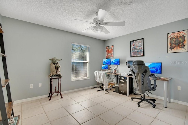 office area with a textured ceiling, baseboards, a ceiling fan, and tile patterned floors