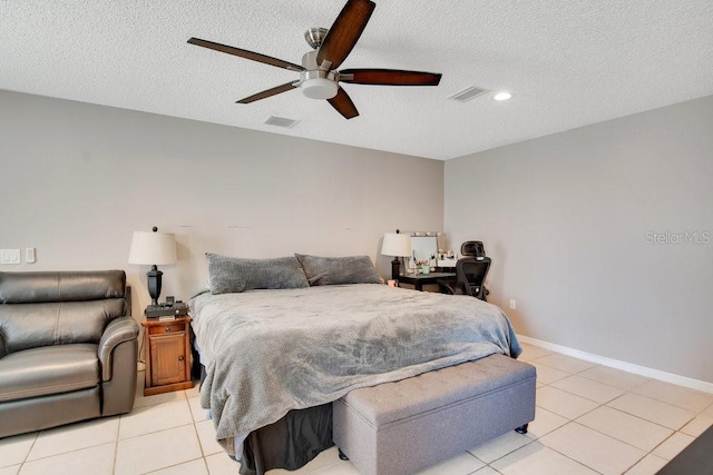 bedroom featuring a textured ceiling, light tile patterned flooring, visible vents, and baseboards