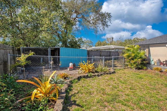 view of yard with fence and an outdoor structure