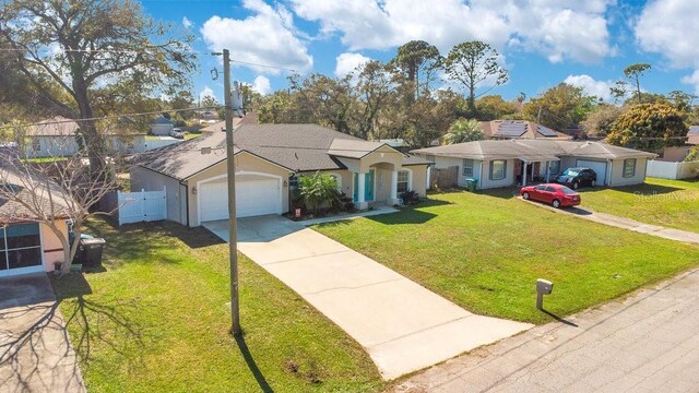 single story home featuring driveway, a garage, fence, and a front lawn