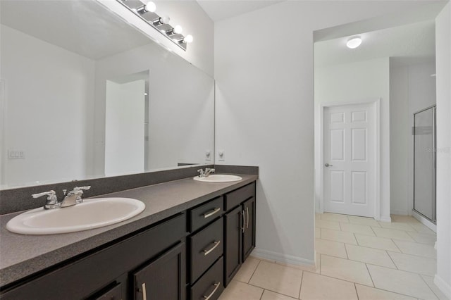 full bathroom featuring double vanity, tile patterned flooring, a sink, and a shower stall