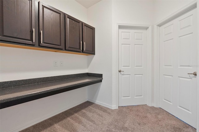 interior space with carpet and baseboards