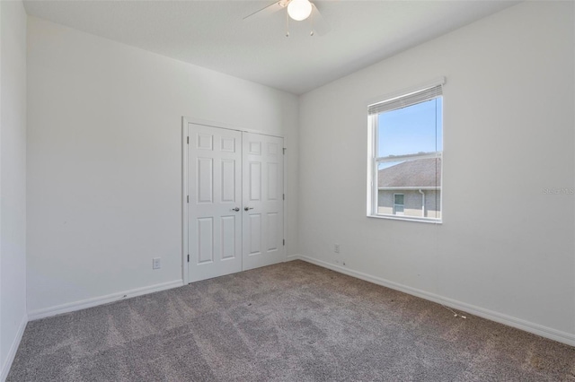 unfurnished bedroom with carpet floors, a closet, and baseboards