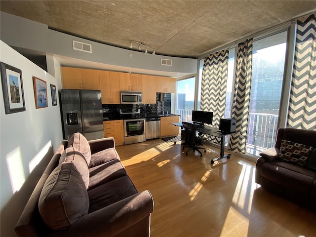 living room with light wood finished floors and visible vents