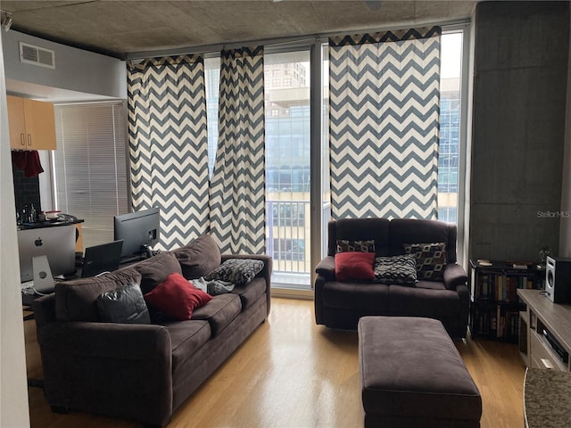 living area featuring light wood finished floors and visible vents