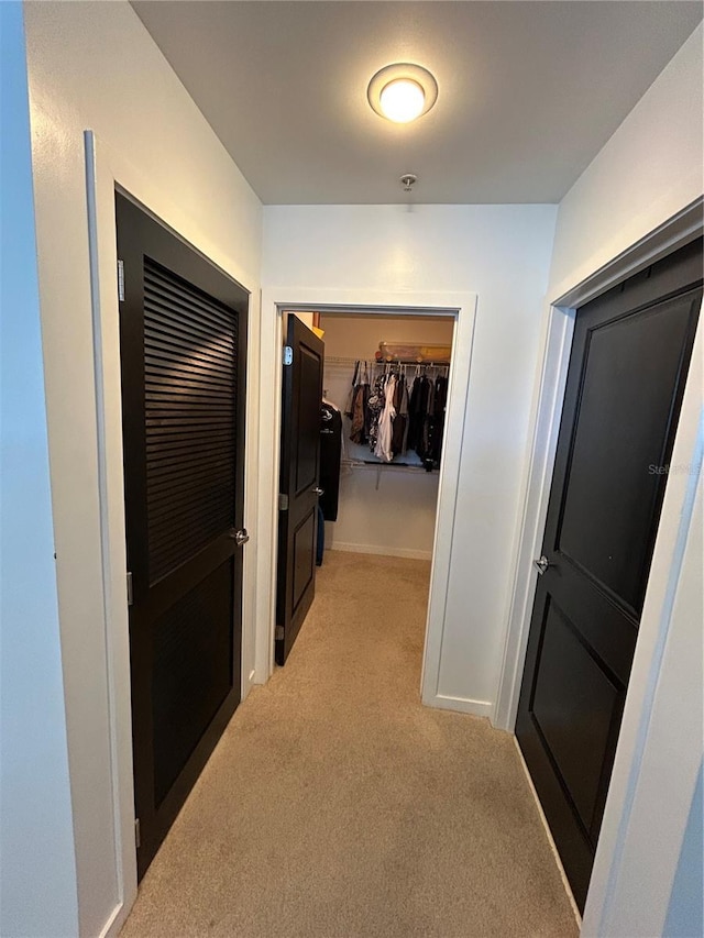 corridor featuring light colored carpet