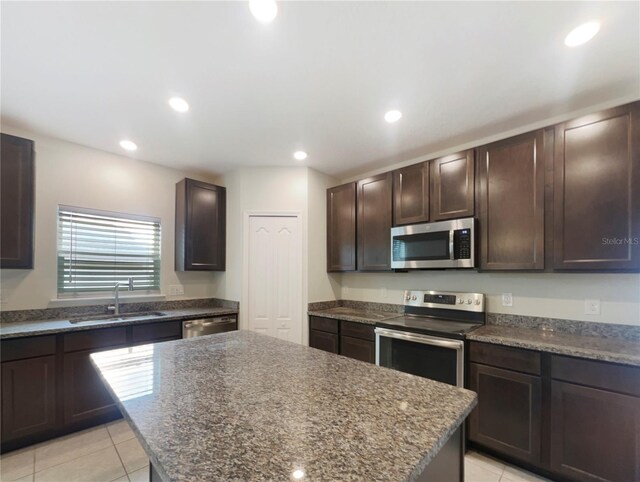 15120 Zenith Ave, Mascotte, FL 34753 - kitchen featuring recessed lighting, appliances with stainless steel finishes, a sink, a kitchen island, and dark brown cabinets