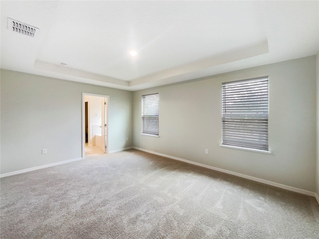 15120 Zenith Ave, Mascotte, FL 34753 - carpeted spare room with a raised ceiling, visible vents, and baseboards