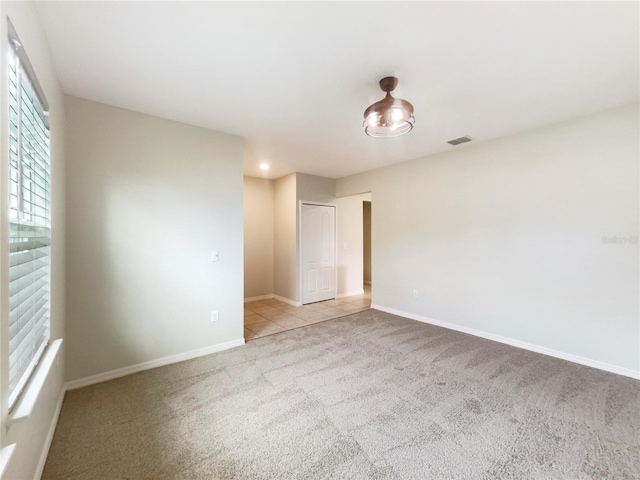 15120 Zenith Ave, Mascotte, FL 34753 - empty room with carpet, visible vents, and baseboards