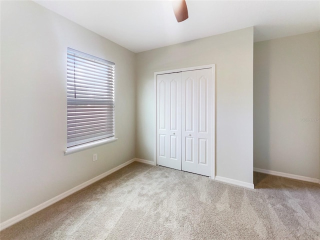 15120 Zenith Ave, Mascotte, FL 34753 - unfurnished bedroom with a ceiling fan, baseboards, a closet, and carpet flooring