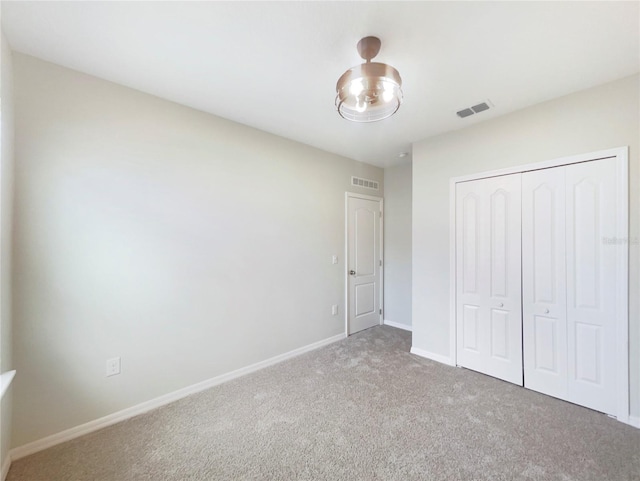 15120 Zenith Ave, Mascotte, FL 34753 - unfurnished bedroom featuring carpet floors, baseboards, visible vents, and a closet