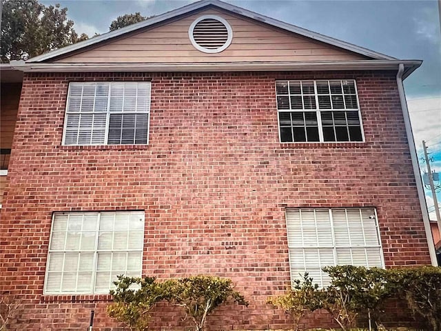 view of side of property with brick siding