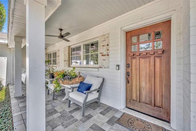 property entrance featuring covered porch and ceiling fan