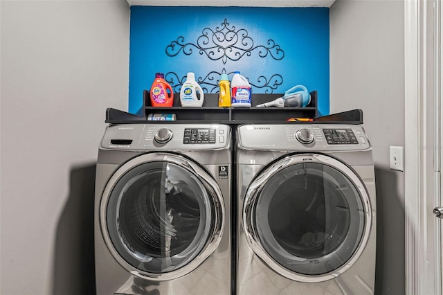 laundry room featuring laundry area, washer and clothes dryer, and tile patterned flooring