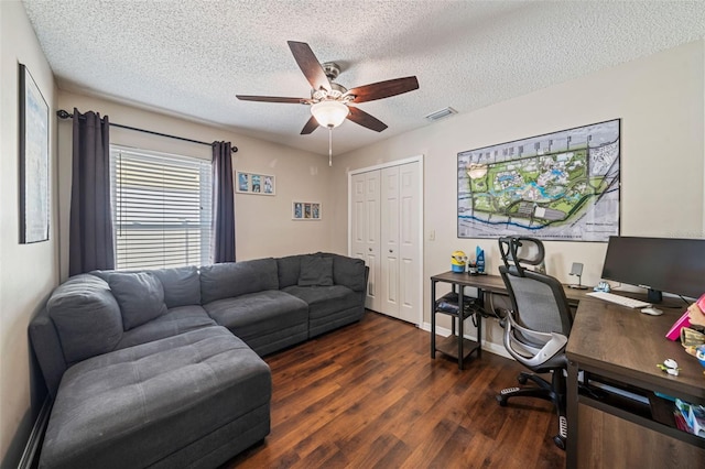 office area featuring a textured ceiling, wood finished floors, visible vents, baseboards, and a ceiling fan