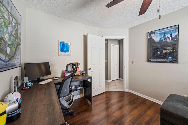 office area with baseboards, a textured ceiling, a ceiling fan, and wood finished floors