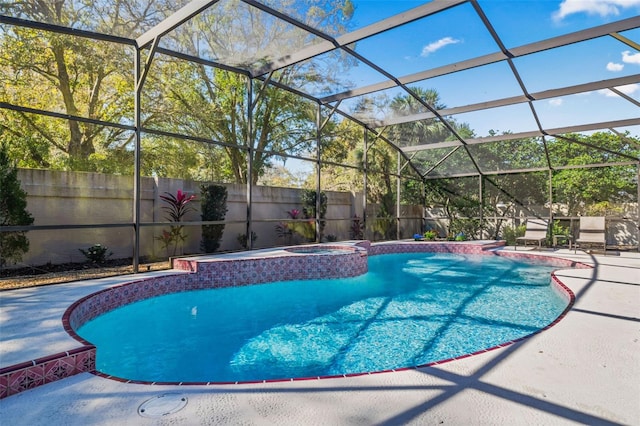 view of pool featuring a lanai, a patio area, a fenced backyard, and a pool with connected hot tub